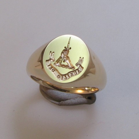 two hands holding dagger crest signet ring